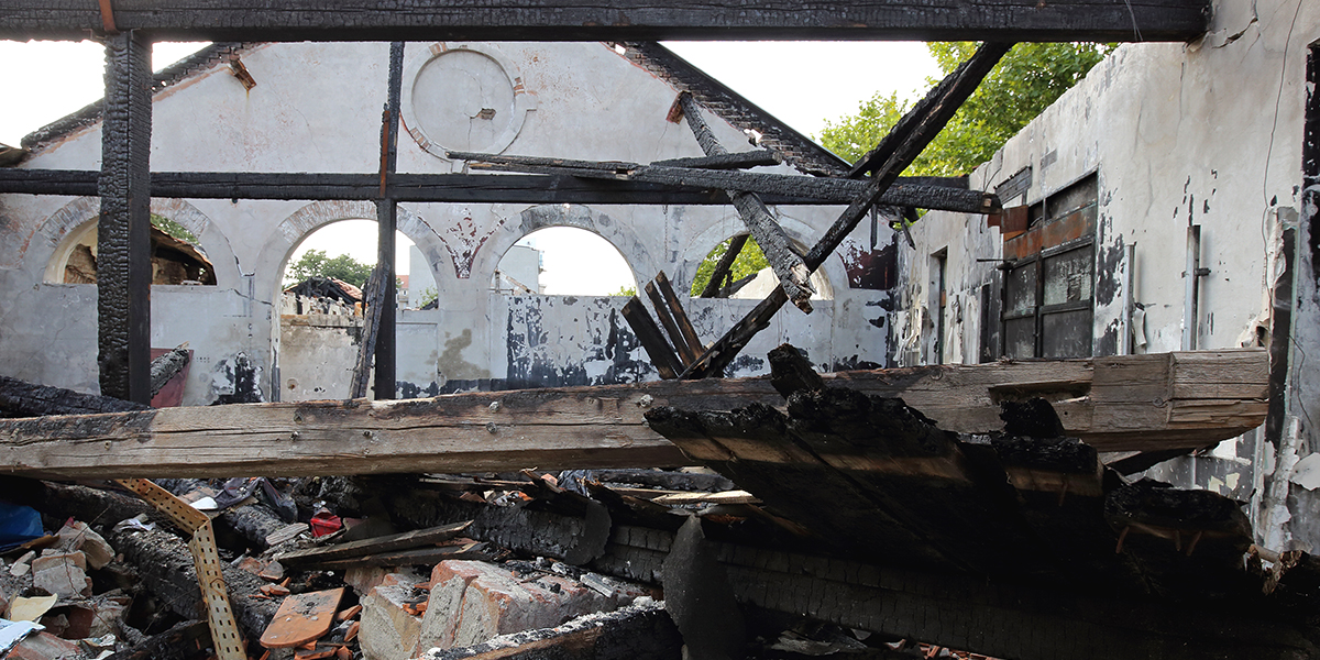 charred remains of burned down building structure